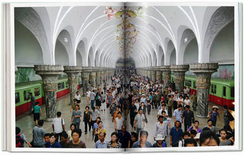 TASCHEN Inside North Korea captures crowds moving through ornate subway stations with white vaulted ceilings, decorative columns, murals, and green and red trains lining bustling platforms.