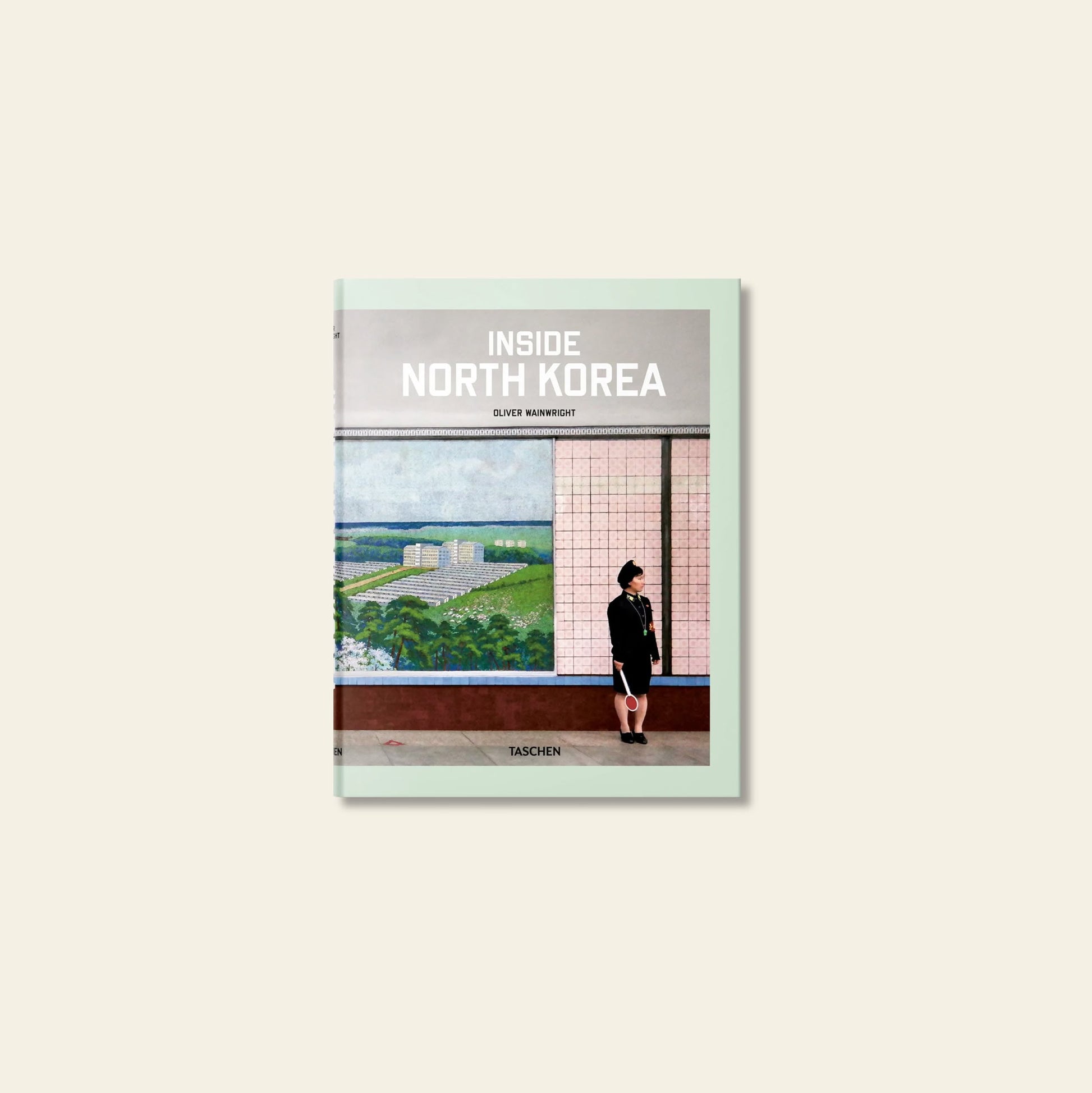 The TASCHEN Inside North Korea book cover by TASCHEN shows a person indoors in front of a mural with green fields and buildings, evoking architectural exploration. The product name is displayed at the top.