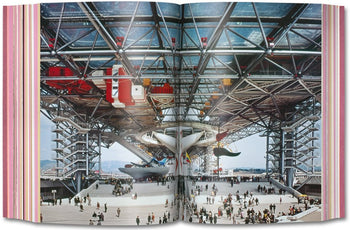 A spacious pavilion with a futuristic steel framework, suspended aircraft, and lively crowds evokes Metabolist architecture, as featured in TASCHEN Project Japan: Metabolism Talks by TASCHEN in a glossy, colorful spread with striped edges.