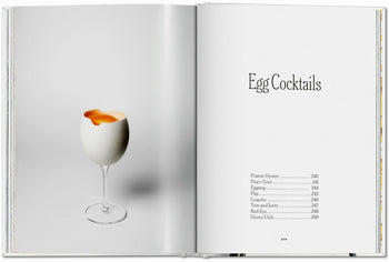 An open book, TASCHEN The Gourmands Egg: A Collection of Stories and Recipes, shows an egg in a wine glass on one page and the title Egg Cocktails with original recipes and page numbers on the other, blending food and art.