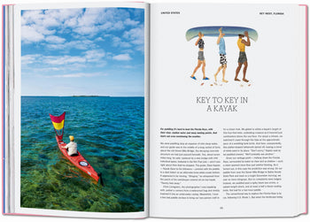 On the left page of TASCHEN The New York Times Explorer: 100 Dream Trips Around the World, someone paddles a red kayak on turquoise water by a small island; the right shows four people carrying a kayak and an article titled Key to Key in a Kayak.