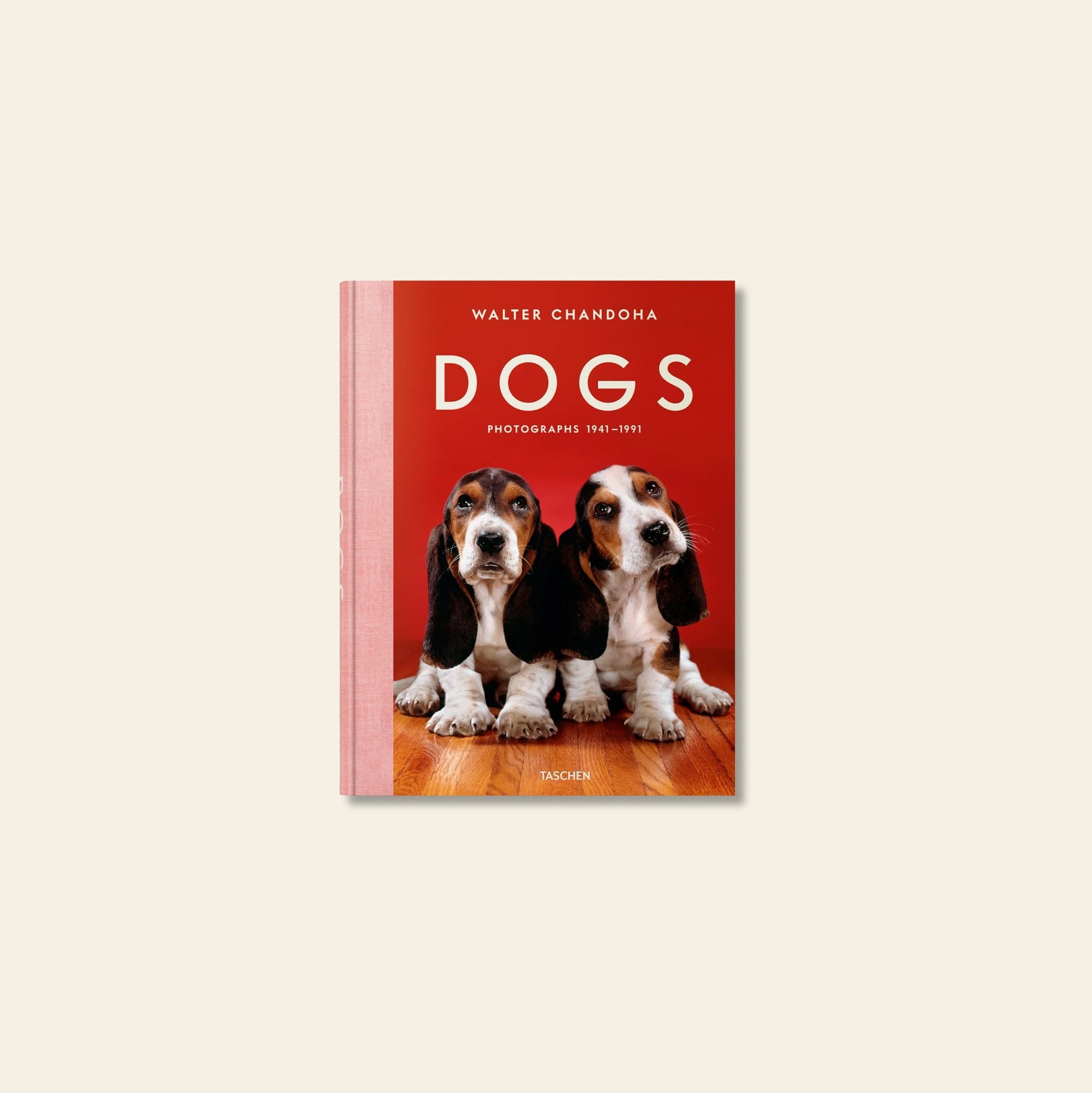 The TASCHEN book Walter Chandoha. Dogs. Photographs 1941-1991 features a cover photo of two basset hounds sitting on a wooden floor against a red background.