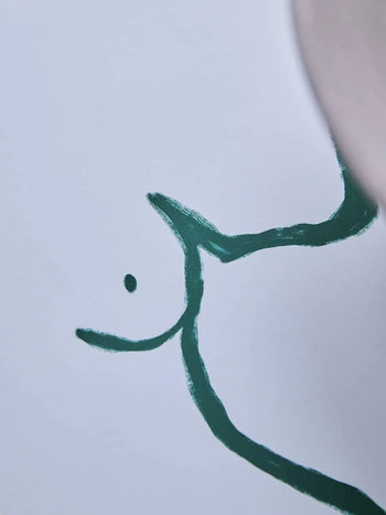 The Poster Club Anna Mörner - Statue (50x70) is a minimalist fine art giclée print featuring a simple green brushstroke and black dot on white, evoking an abstract face. Printed on premium art paper by The Poster Club.