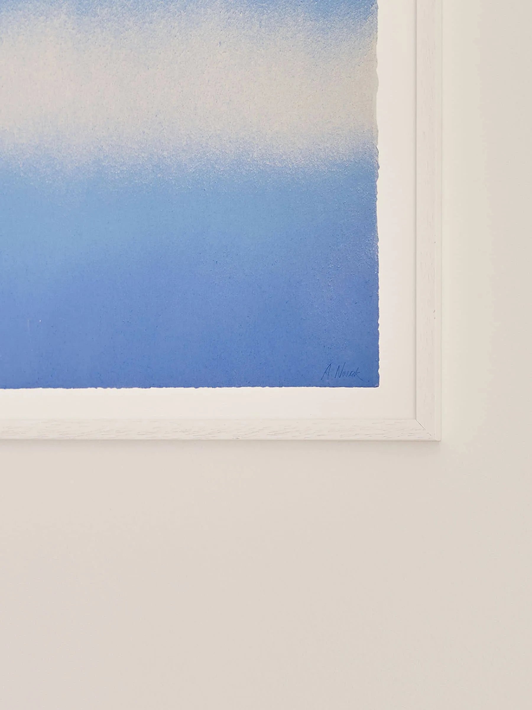 The Poster Club’s Anne Nowak - Blue Interstellar (30x40) shows a blue-to-white gradient, seen in partial view with just the bottom right corner of the artwork and frame against a white wall.