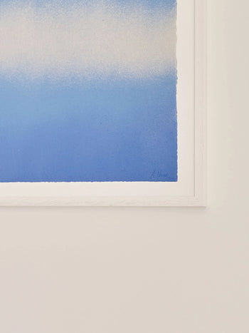 The Poster Club’s Anne Nowak - Blue Interstellar (30x40) shows a blue-to-white gradient, seen in partial view with just the bottom right corner of the artwork and frame against a white wall.