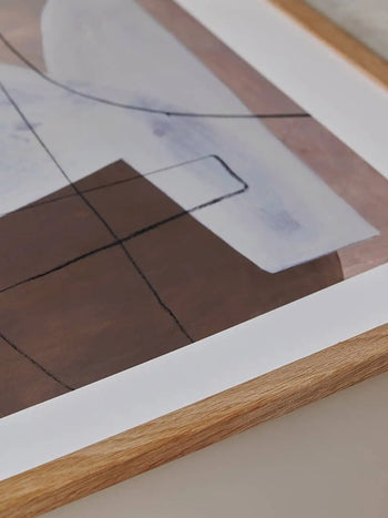 The Poster Club Berit Mogensen Lopez - Improvise (50x70) features abstract shapes in white, brown, and gray with black lines in a light wooden frame, offering a clean modern look by The Poster Club.