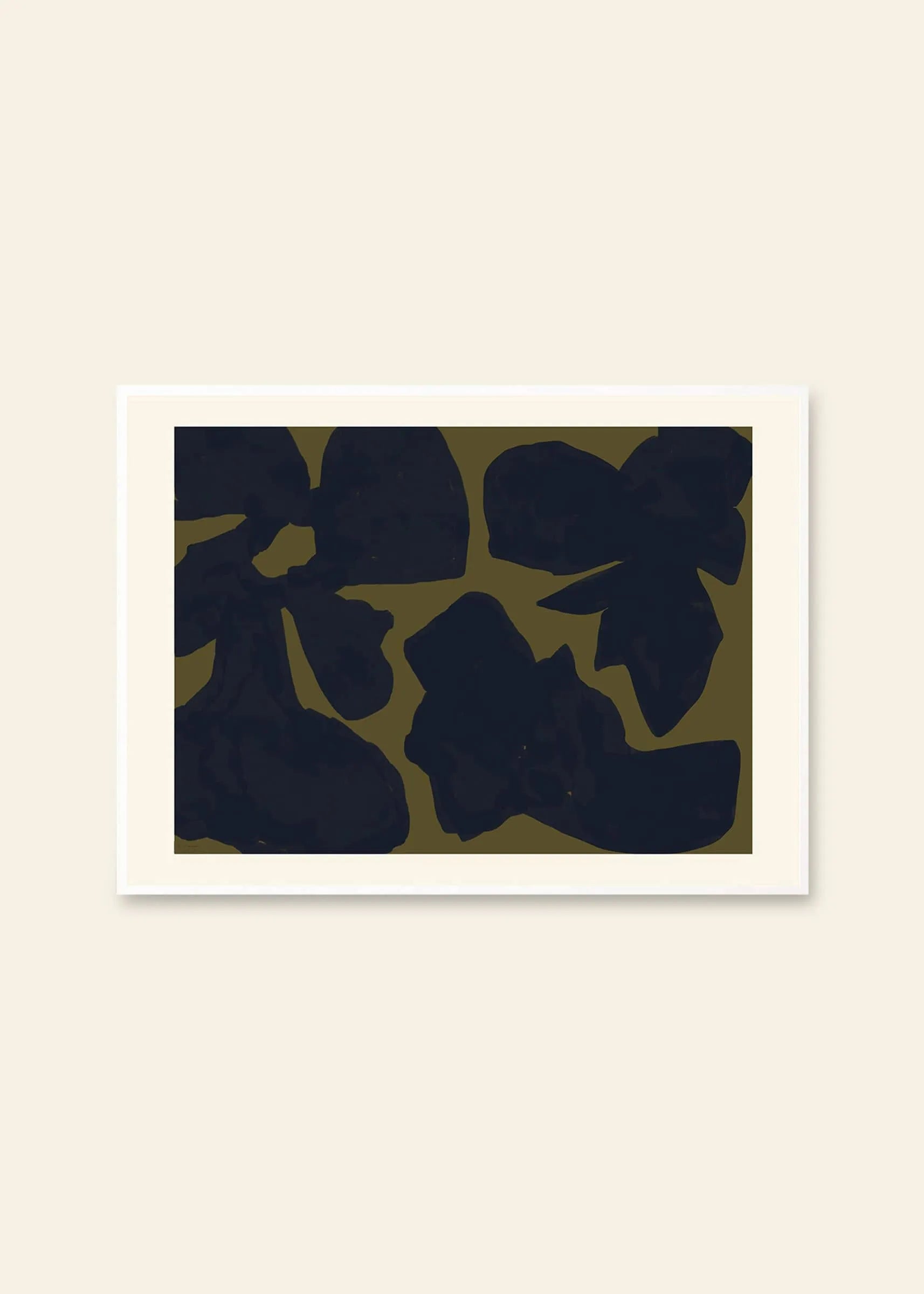 By Garmi - Desoleil (30x40) art print from The Poster Club features large, irregular dark shapes on an olive green background, bordered by a white mat and displayed against a light beige wall.