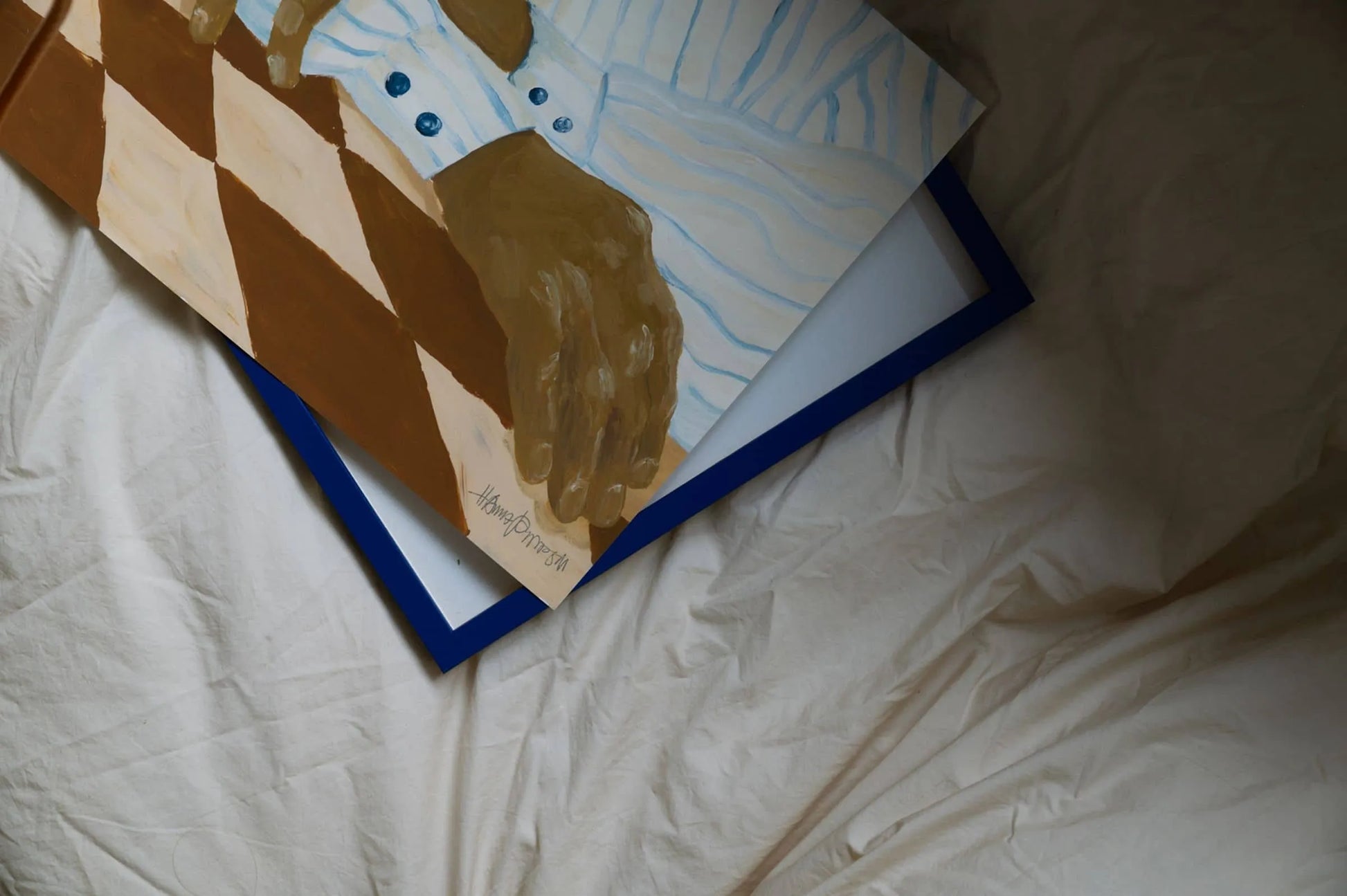 Hanna Peterson’s Light Stripes (30x40) art print, showing a brown-skinned hand in a blue-striped shirt on a blue-edged frame over white fabric, is available at The Poster Club.
