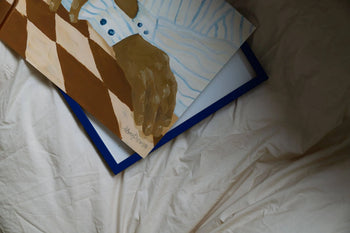 Hanna Peterson’s Light Stripes (30x40) art print, showing a brown-skinned hand in a blue-striped shirt on a blue-edged frame over white fabric, is available at The Poster Club.