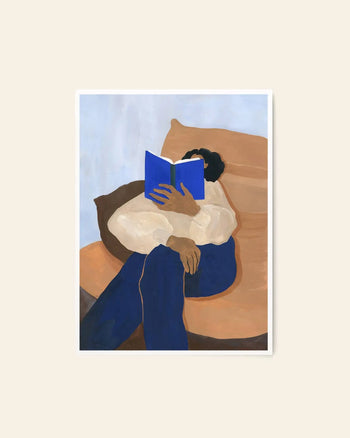 The Poster Club Hanna Peterson - The Togo (50x70) features a stylized illustration of a person reading on a couch in soft beige and brown tones—an ideal fine art giclée print from The Poster Club for archival display.