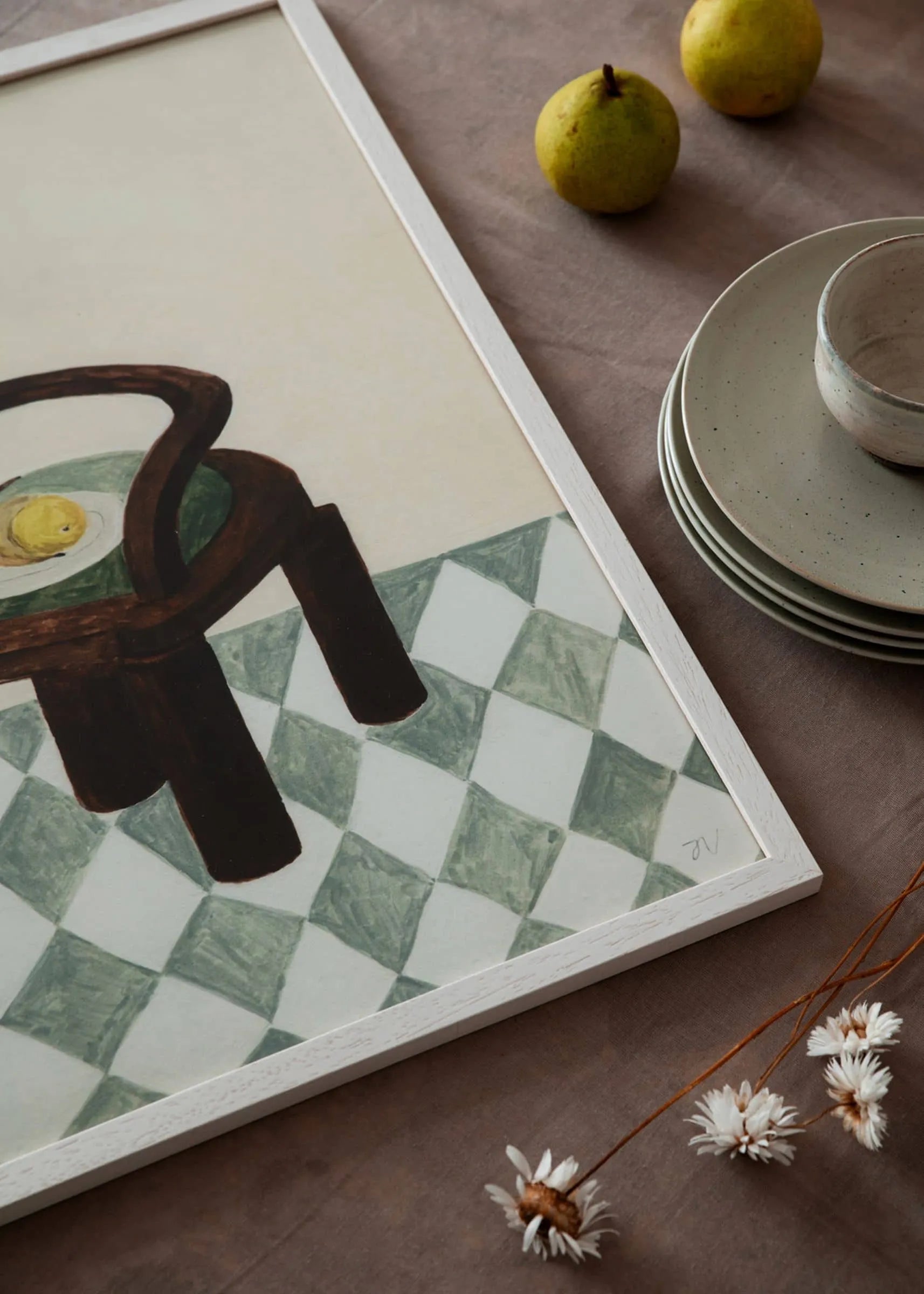 Isabelle Vandeplassche - Chair with Fruit (30x40) by The Poster Club features a chair, lemon, pear, cup, stacked dishes, and dried flowers on a green and white checkered floor. Exclusively at The Poster Club.