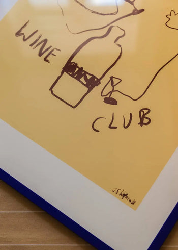 The Poster Club Ruby Hughes – Wine Club (50x70) features a playful drawing of a wine bottle, glass, and “WINE CLUB” text on yellow paper. This fine art giclée print from The Poster Club includes the artist’s signature.