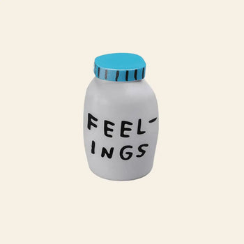 The Third Drawer Down Adam JK - Feelings Stress Toy is a white jar with a blue lid and “FEELINGS” in black, uneven letters on the front—perfect for squeezing out emotions you wish to release.