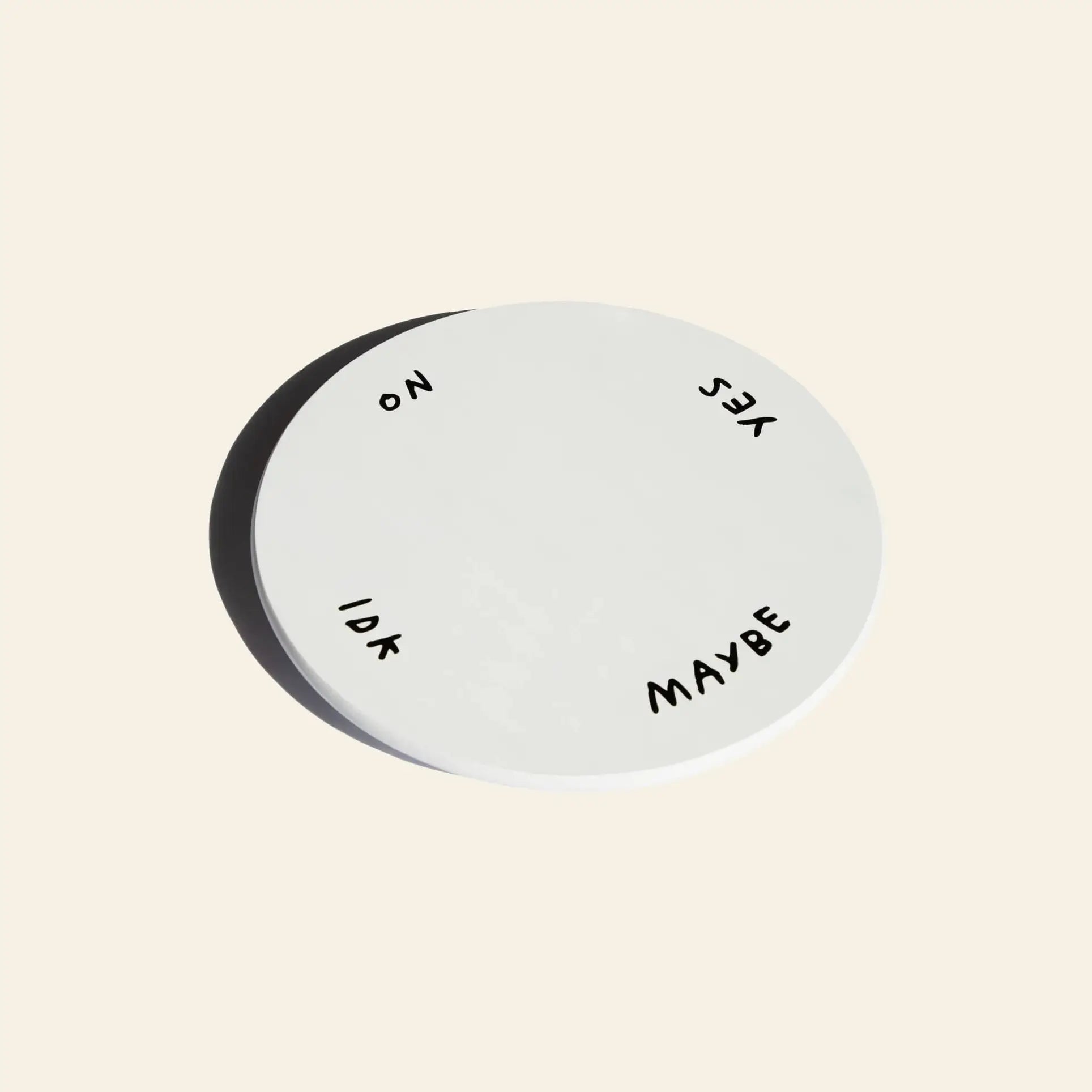 The Third Drawer Down Adam JK - Indecisive Lazy Susan is a white circular piece with YES, MAYBE, IDK, and NO along the edge—a playful decision-making tool by Adam JK from Third Drawer Down.