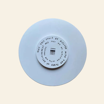 The Third Drawer Down Adam JK - Indecisive Lazy Susan is a white circular piece featuring a smaller inner circle and black handwritten text by Adam JK: May this space be blessed with decisiveness; may we be critical and honest.