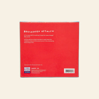 The back of the Third Drawer Down Adam JK - Nothing Matters Ceramic Trays red box features white text describing its playful reminder to find humor in uncertainty. Brand logos and care instructions are shown at the bottom.