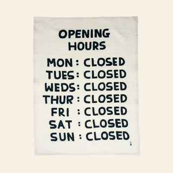 The Third Drawer Down David Shrigley - Opening Hours Tea Towel features his signature black and white style with a quirky list: MON-SUN: CLOSED—a playful, artful touch from Third Drawer Down.