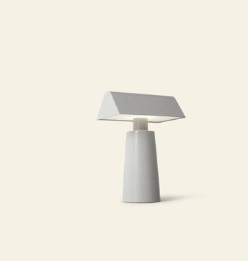 The &Tradition Caret MF1 Portable Table Lamp features a minimalist white conical base and slanted rectangular shade—an ideal modern design piece from &Tradition for any contemporary space.