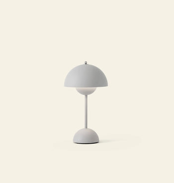 The &Tradition Flowerpot VP9 Portable Table Lamp features a modern dome-shaped shade and sleek stand, shown on a light beige background. This minimalist piece includes a USB charging cable for convenient use anywhere.