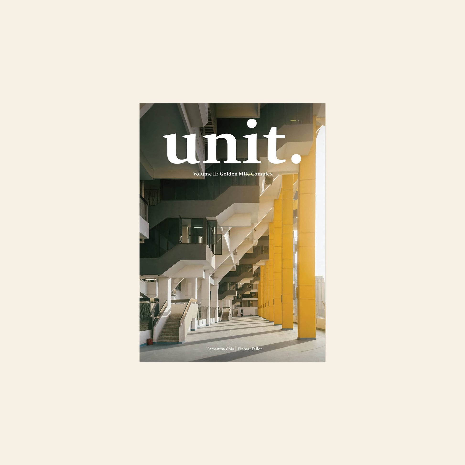 The UNIT. Volume 2: Golden Mile Complex magazine cover features a striking photo of the Golden Mile Complex, highlighting geometric stairs and yellow pillars, with sunlight streaming in.