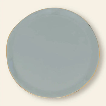 The Urban Nature Culture Good Morning Breakfast Plate features a round, light gray design with a slightly irregular edge and thin gold rim, set against an off-white background for a refined, modern look.