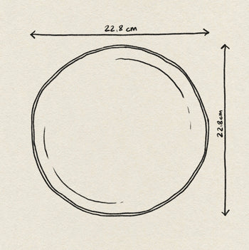A hand-drawn illustration of the Urban Nature Culture Good Morning Breakfast Plate by Urban Nature Culture, shaded in pastels, displays its 22.8 cm width and height labeled with arrows above and to the right marking the measurements.