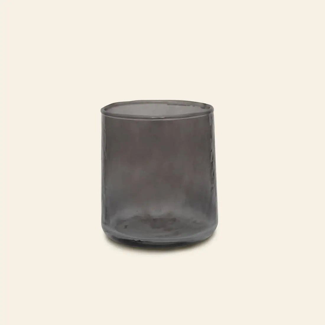 The Urban Nature Culture Tumbler Recycled Glass, in transparent smoky gray, is pictured against a plain light beige background.