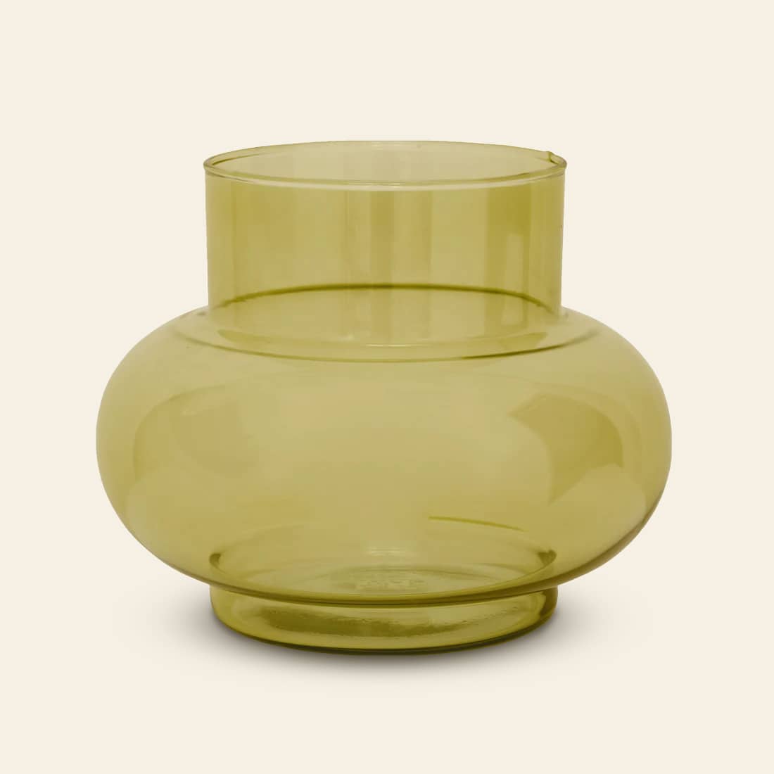 The Urban Nature Culture Vase Recycled Glass Tummy B is a translucent, light yellow vase with a wide, rounded body and short cylindrical neck—an elegant home décor piece by Urban Nature Culture, shown on a plain, off-white background.