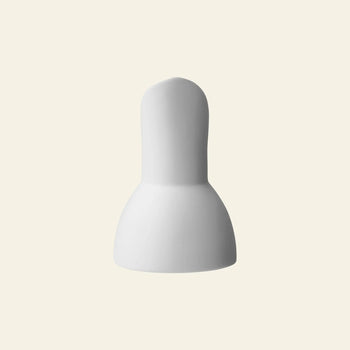The Vipp Vipp205 Milk Jug by Vipp is a white, bulb-shaped jug with a rounded top, wide base, and unique tilted spout, shown against a plain light beige background.