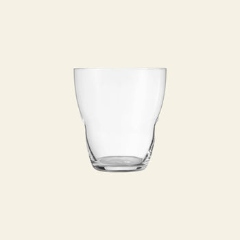 The Vipp Vipp240 Glasses 5oz, Set of 2 by Vipp are shown empty against a light beige background, highlighting their luxury design with a simple curved shape and thick base—a testament to mouth-blown craftsmanship.