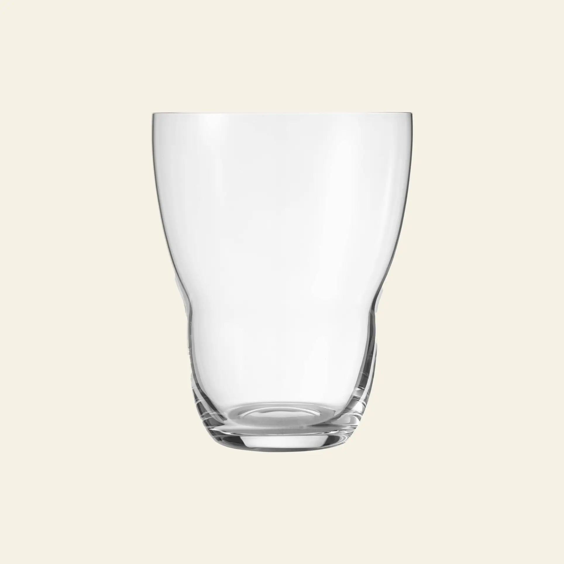 The Vipp Vipp242 Glasses 11oz, Set of 2 by Vipp feature clear, gently curved shapes with thick bases and hand-polished finishes, beautifully displayed against a light beige background.