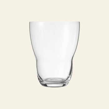 The Vipp Vipp242 Glasses 11oz, Set of 2 by Vipp feature clear, gently curved shapes with thick bases and hand-polished finishes, beautifully displayed against a light beige background.