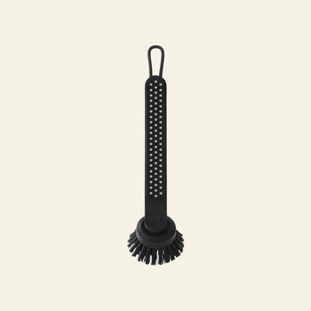 The Vipp Vipp280 Dishwashing Brush by Vipp features a long handle with dotted texture, a round replaceable brush head, and a hanging loop—ideal for efficient kitchen cleaning. Shown against a plain beige background.