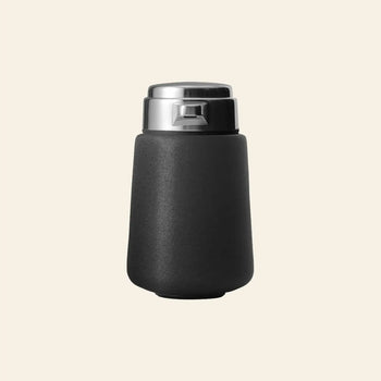 The Vipp Vipp9 Dispenser by Vipp, with a sleek black matte finish and stainless steel lid, is displayed on a light beige background—a must-have kitchen accessory for enjoying drinks while on the move.