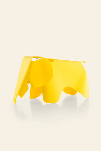 The Vitra Eames Elephant, Small by Vitra is a bright yellow, smooth plastic decorative piece with a minimalist design and abstract details—an iconic, playful accent for any modern space.