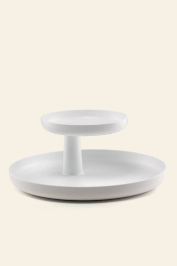 The Vitra Rotary Tray by Vitra is a minimalist, modern two-tiered white tray with a central column for stylish storage, showcased against an off-white background.