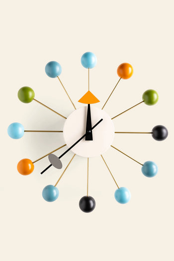 The Vitra Wall Clock - Ball Clock by Vitra brings modern flair to any room with its white face, bold black hands, and colorful blue, green, orange, and gray spheres on gold rods marking each hour.