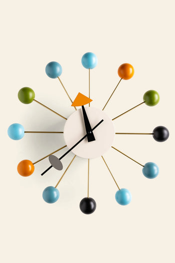The Vitra Wall Clock - Ball Clock by Vitra features a white circular face, black hands, and colorful balls on rods in a starburst pattern, adding a modern touch to any space.