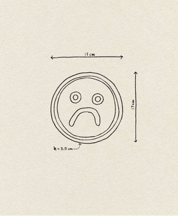 The Wobbly Studio Mood Tray features a hand-drawn sad face in a 17 x 17 cm circle with a 3.5 cm mouth, displayed on textured beige paper—perfect for personalizing your space.