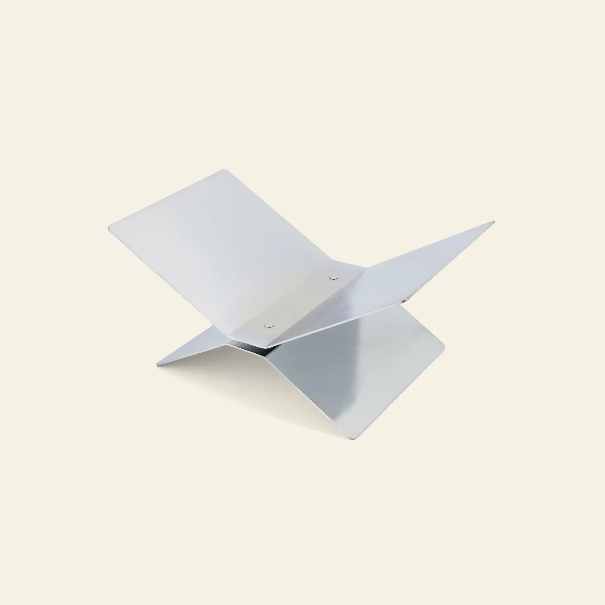 The baebsy Atlas Bookstand by baebsy features a minimalist, modern design with two interlocking flat panels forming an X shape, creating a levitation effect. It is shown against a plain light background.
