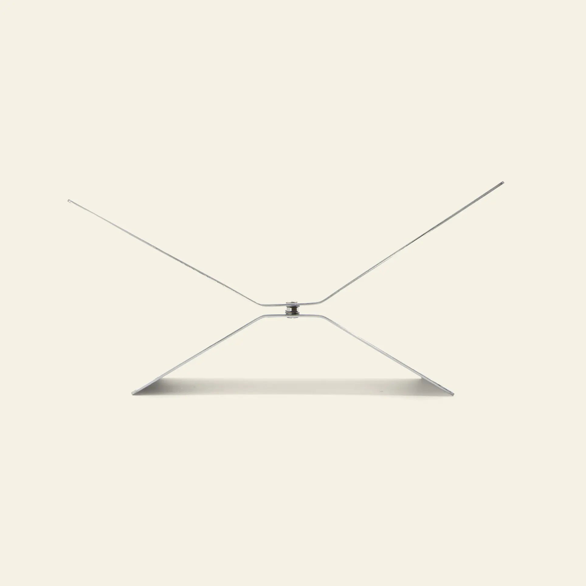 The baebsy Atlas Bookstand by baebsy is a minimalist silver metal stand with a geometric, angular levitation design, shown against a plain light beige background.