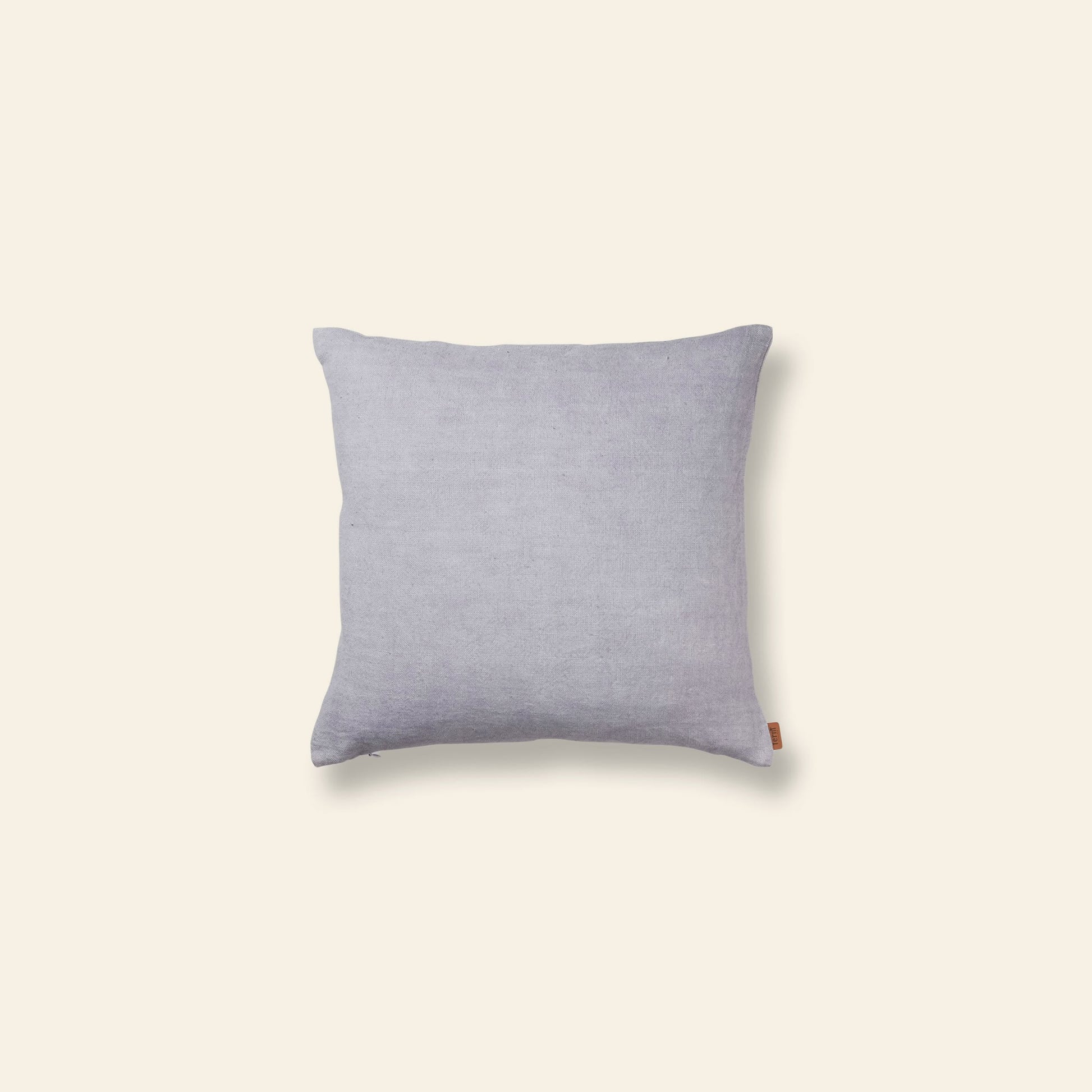 The ferm LIVING Contrast Linen Cushion features light gray linen with subtle texture and contrast stitching, shown against a plain beige background.