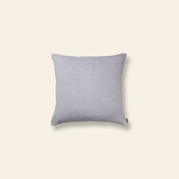 The ferm LIVING Contrast Linen Cushion features light gray linen with subtle texture and contrast stitching, shown against a plain beige background.