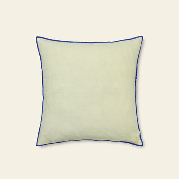 The ferm LIVING Contrast Linen Cushion is a square, light beige cushion with contrast stitching and a small fruit embroidery in one corner, shown against a plain, light background.