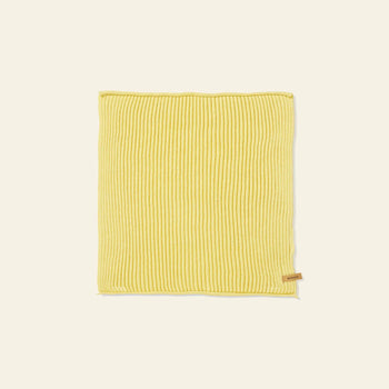 A set of 7 ferm LIVING Day Cloths, each neatly folded and rectangular, made from organic cotton in yellow ribbed knit with a small tan tag on one edge, displayed on a plain light background.