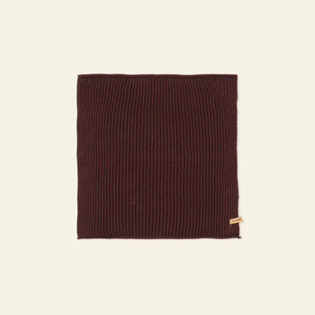 A set of 7 rectangular, ribbed, dark brown knit cloths by ferm LIVING, made from GOTS-certified organic cotton with a small beige tag on the bottom right, displayed on a plain light background.