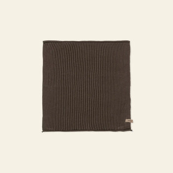A set of ferm LIVING Day Cloths (Set of 7) in dark brown ribbed knit organic cotton is laid flat on a light beige background, with a small fabric tag attached near one edge.