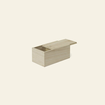 A rectangular wooden box with a sliding lid, shown partially open against a plain light beige background—ideal for storing the ferm LIVING Doodle Glasses Low, Set of 2 by ferm LIVING, crafted from durable borosilicate glass with unique patterns.