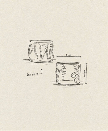 A hand-drawn sketch depicts the ferm LIVING Doodle Glasses Low, Set of 2—borosilicate glasses with unique wavy line patterns. One glass measures 8 cm in width and the other 6.5 cm in height.