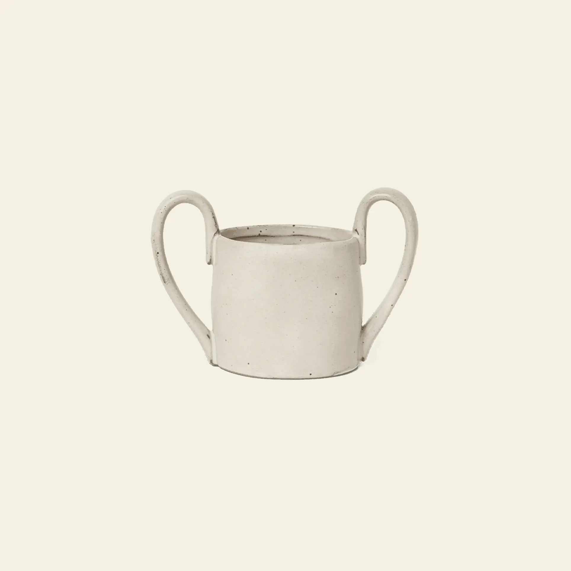 The ferm LIVING Flow Mug Mini is a minimalist, off-white ceramic mug with two large curved handles, featuring modern design by ferm LIVING and presented against a plain light beige background.